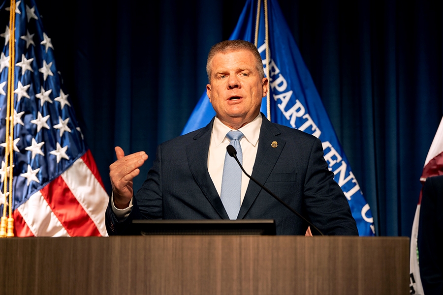 DEA Acting Administrator Robert J. Murphy delivers remarks from a podium at the Drug Enforcement Administration Headquarters. He is joined by Attorney General Pamela Bondi.